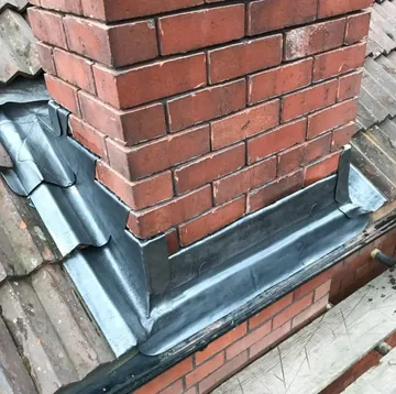 Lead flashing at a brick chimney
