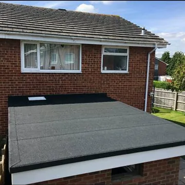 Flat roof adjoining a brick house